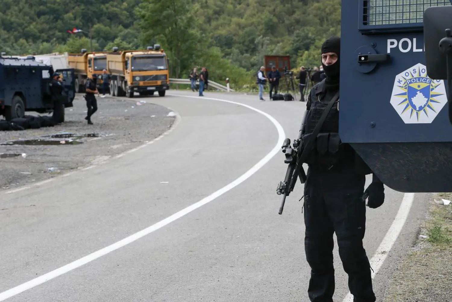Kosovo police officers patrol a road near the northern Kosovo border crossing of Jarinje, Tuesday, Sept. 21, 2021. (AP Photo/Visar Kryeziu)

