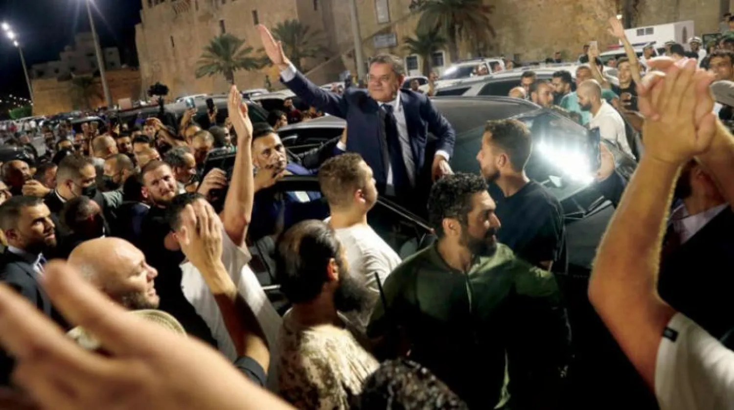 Libya's interim Prime Minister Abdul Hamid Dbeibah greets a crowd in Tripoli's Martyrs Square on September 21, 2021. (Photo by Mahmud Turkia / AFP)