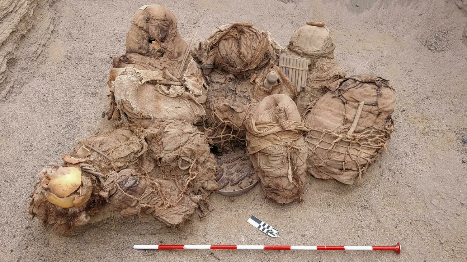 A handout picture released by Peruvian gas company Calidda, shows objects, food, artifacts and ancient funeral bundles containing the remains of eight people unearthed by workers. Jesus BAHAMONDE Calidda/AFP
