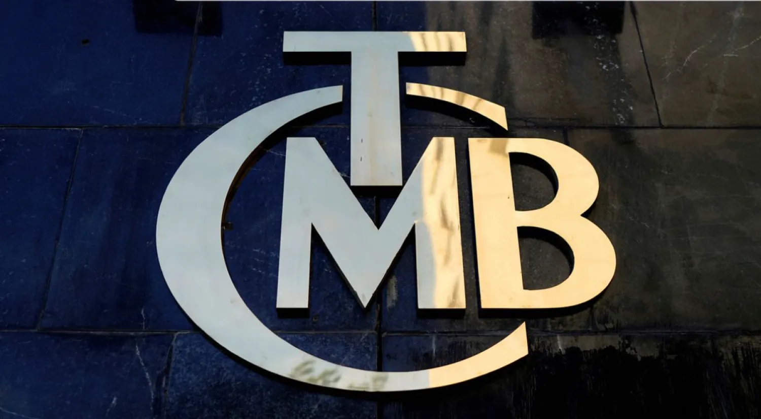 A logo of Turkey's Central Bank (TCMB) is pictured at the entrance of the bank's headquarters in Ankara, Turkey April 19, 2015. REUTERS/Umit Bektas/File Photo