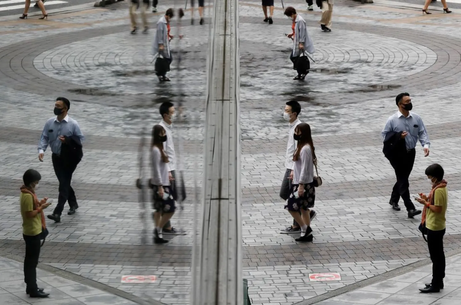 People wearing protective masks, amid the coronavirus disease (COVID-19) outbreak, make their way at a shopping district in Tokyo, Japan, September 9, 2021. REUTERS/Kim Kyung-Hoon


