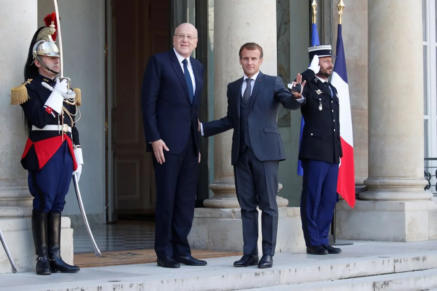 French President Emmanuel Macron welcomes Lebanon's Prime Minister Najib Mikati as he arrives for a working lunch at the Elysee Palace in Paris, France, September 24, 2021. (Reuters)