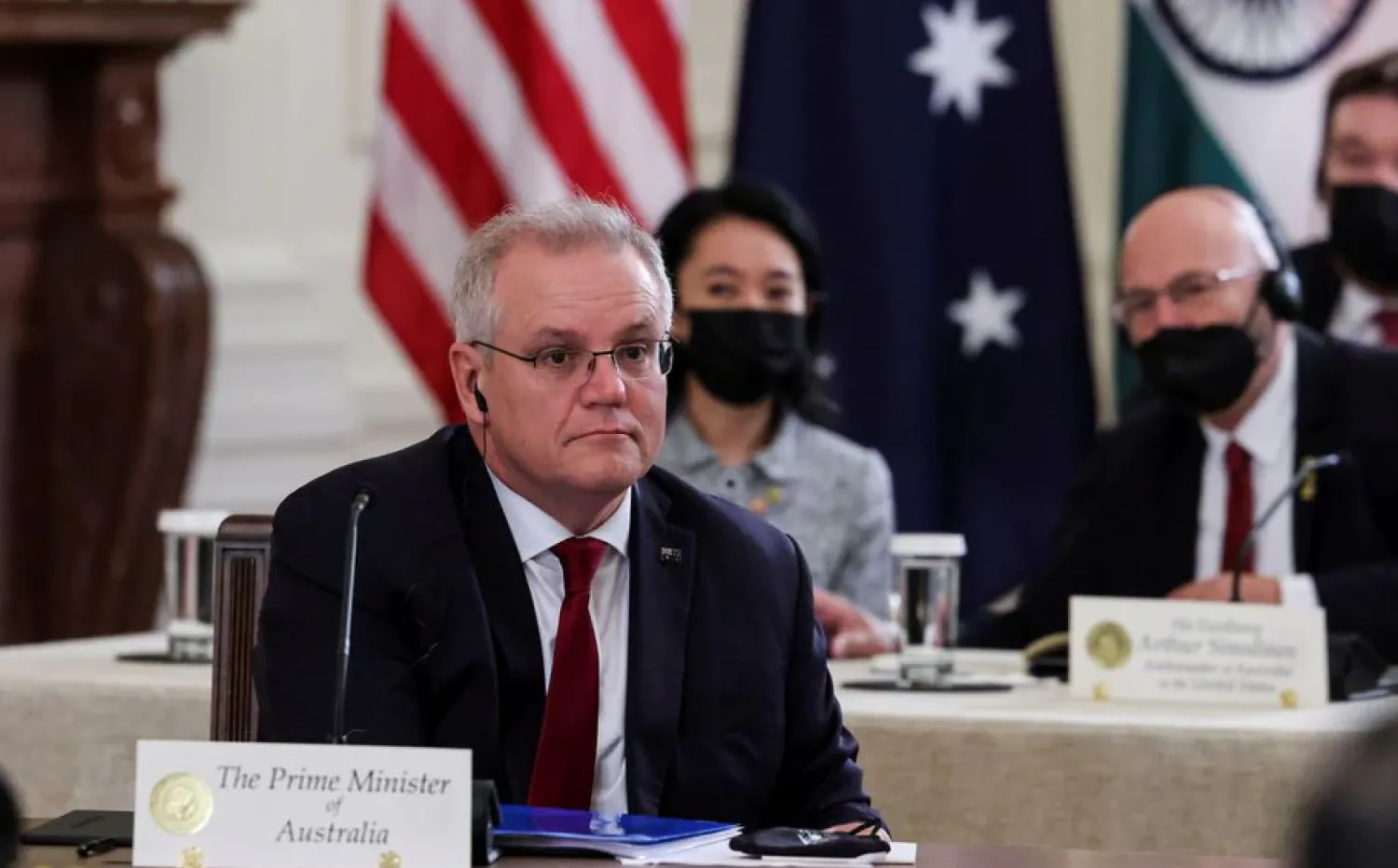 Australia's Prime Minister Scott Morrison is seated with members of his delegation as he participates in a 'Quad nations' meeting at the Leaders' Summit of the Quadrilateral Framework hosted by US President Joe Biden in the East Room at the White House in Washington, US, September 24, 2021. REUTERS/Evelyn Hockstein/File Photo

