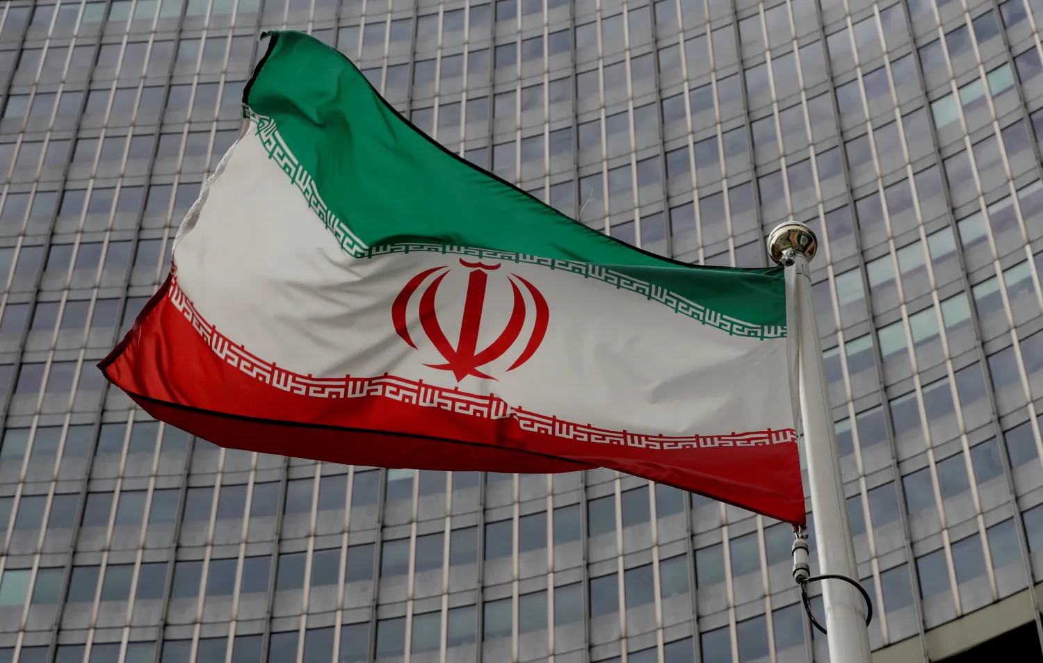 An Iranian flag flutters in front of the International Atomic Energy Agency (IAEA) headquarters in Vienna, Austria, September 9, 2019. REUTERS/Leonhard Foeger/File Photo