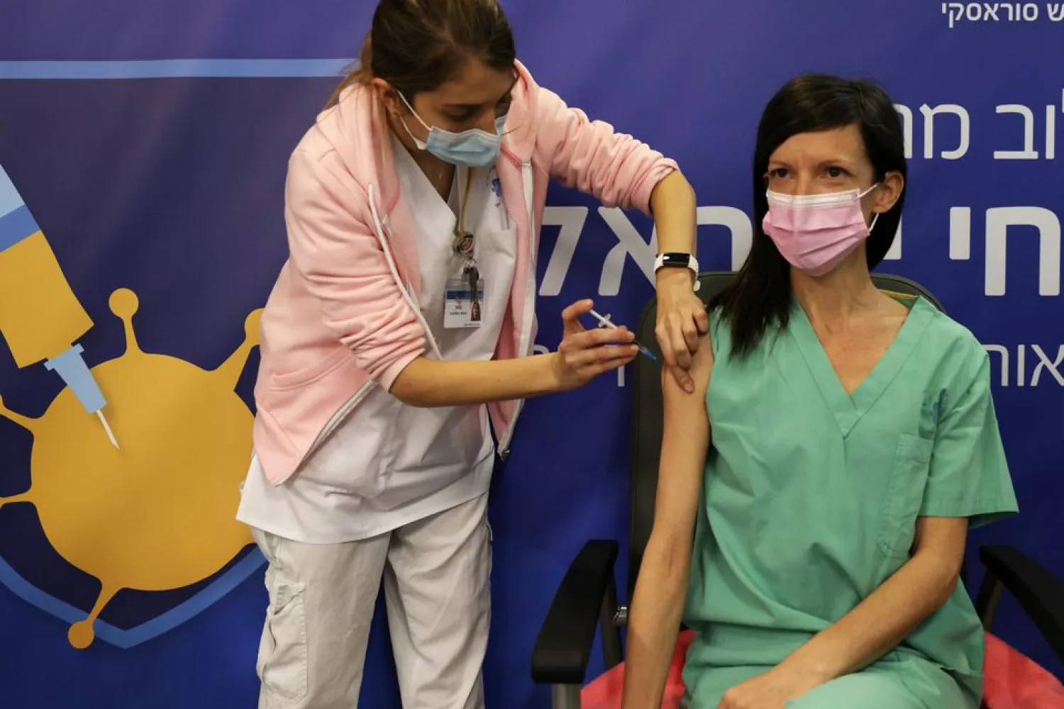 A medical worker gets her second vaccination injection against the coronavirus disease as Israel continues its national vaccination drive, during a third national COVID-19 lockdown, at Tel Aviv Sourasky Medical Center (Ichilov Hospital) in Tel Aviv, Israel January 10, 2021 REUTERS/ Ronen Zvulun
