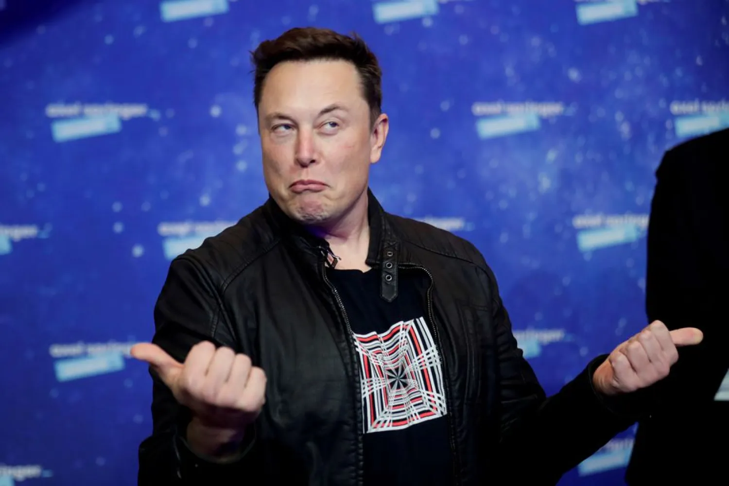 Tesla CEO Elon Musk grimaces after arriving on the red carpet for the Axel Springer award, in Berlin, Germany, December 1, 2020. REUTERS/Hannibal Hanschke/Pool