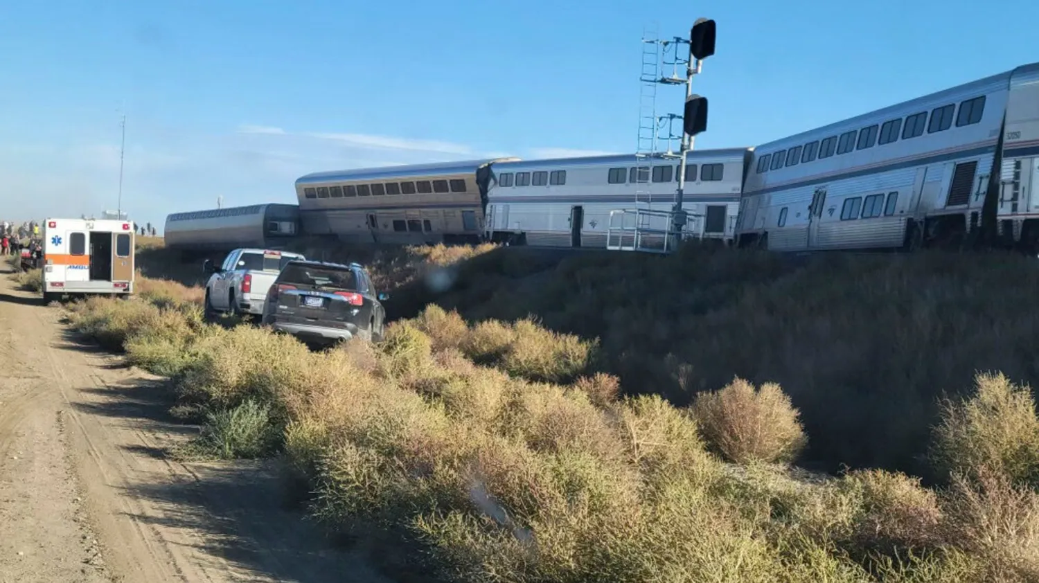 In this photo provided by Kimberly Fossen an ambulance is parked at the scene of an Amtrak train derailment on Saturday, Sept. 25, 2021, in north-central Montana. Kimberly Fossen via AP
