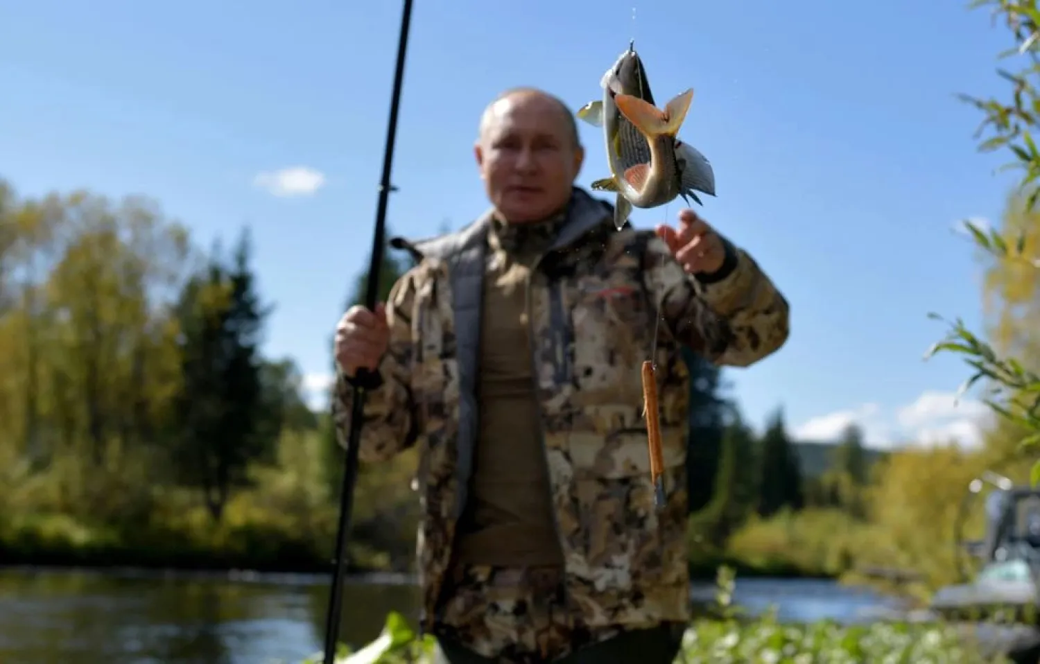 Russian President Vladimir Putin fishes during a short vacation at an unknown location in Siberia, Russia, in this undated photo taken in September 2021 and released September 26, 2021. Sputnik/Alexei Druzhinin/Kremlin via Reuters