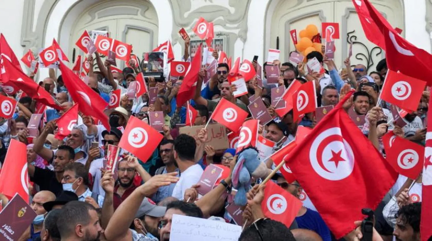 Demonstrators carry flags during a protest against Tunisian President Kais Saied's seizure of governing powers, in Tunis, Tunisia, September 26, 2021. REUTERS/Zoubeir Souissi