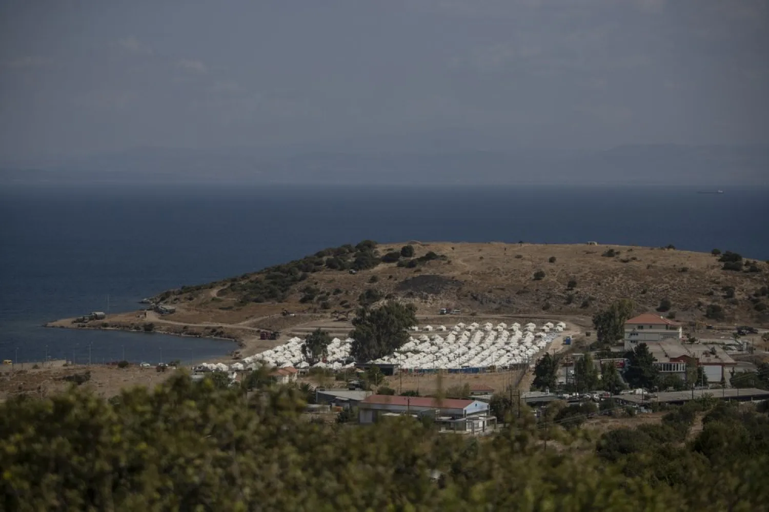 FILE: A general view of the temporary camp for refugees and migrants near Mytilene town, on the northeastern island of Lesbos, Greece, Sunday Sept. 13, 2020.  (AP Photo/Petros Giannakouris)
