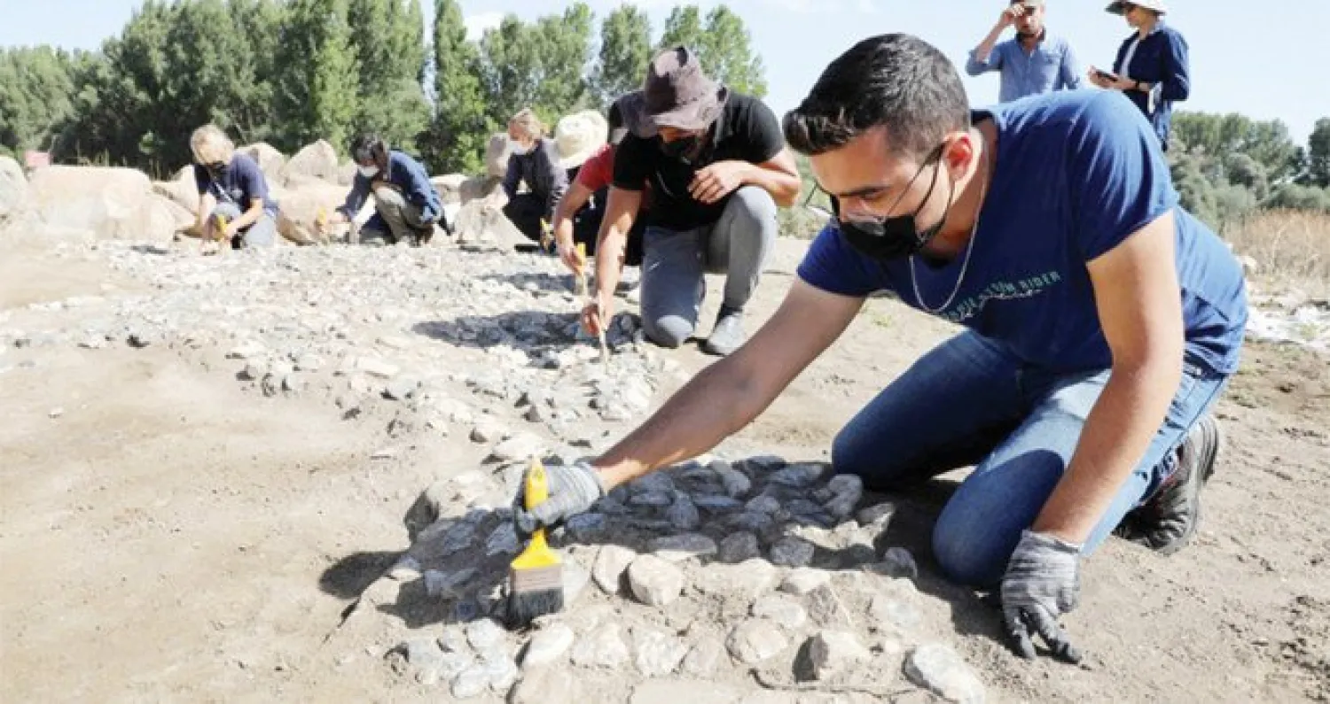 Archaeologists work at the site where a 3,500-year-old paving stone was discovered in Buyuk Taslik village, Turkey. (AFP)
