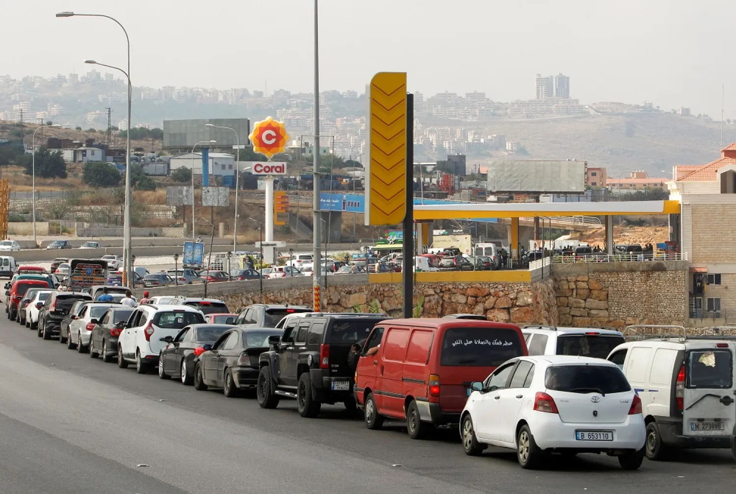 Cars stand queue at a gas station as they wait to fuel up in Damour, Lebanon June 25, 2021. (Reuters)
