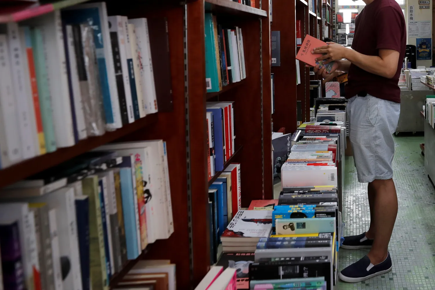 A man reads a book at a bookstore. Reuters