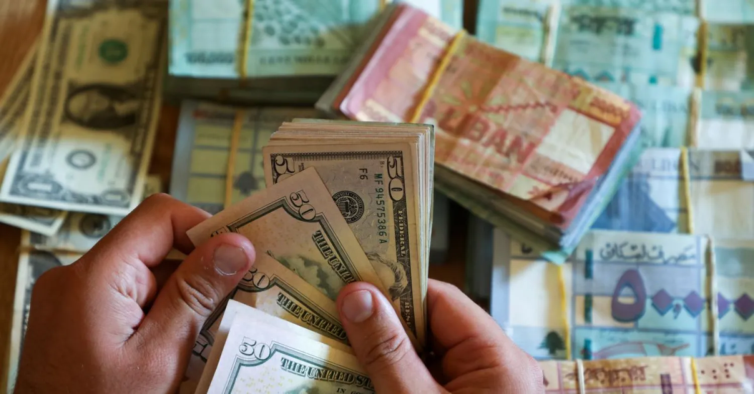 A man counts US dollar banknotes at a currency exchange shop in Beirut, Lebanon, June 11, 2021. (Reuters)