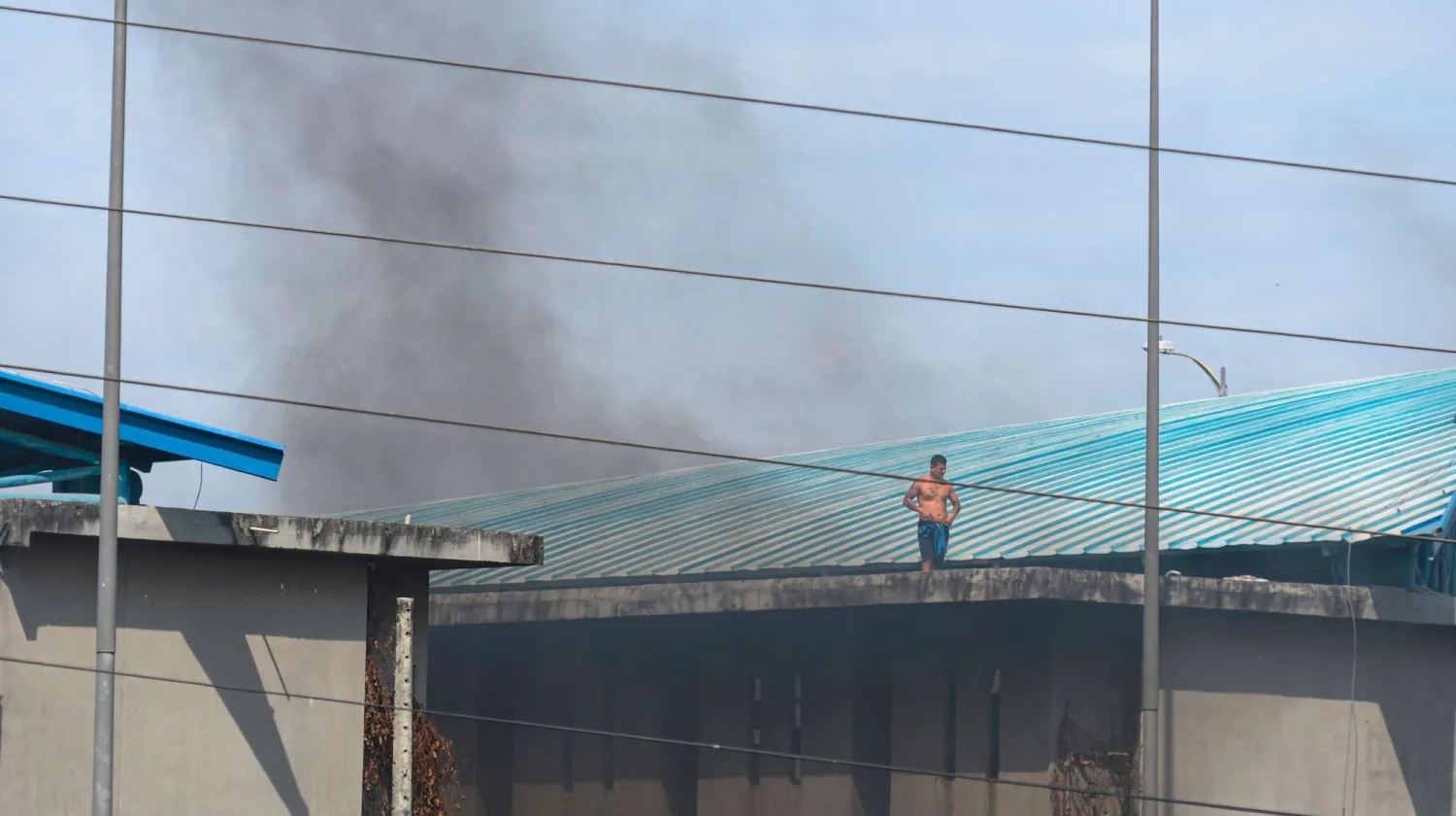 Inmates are seen on top of the prison roof during a riot at the Guayaquil Regional prison in Guayaquil, Ecuador on September 28, 2021. Fernando Mendez, AFP
