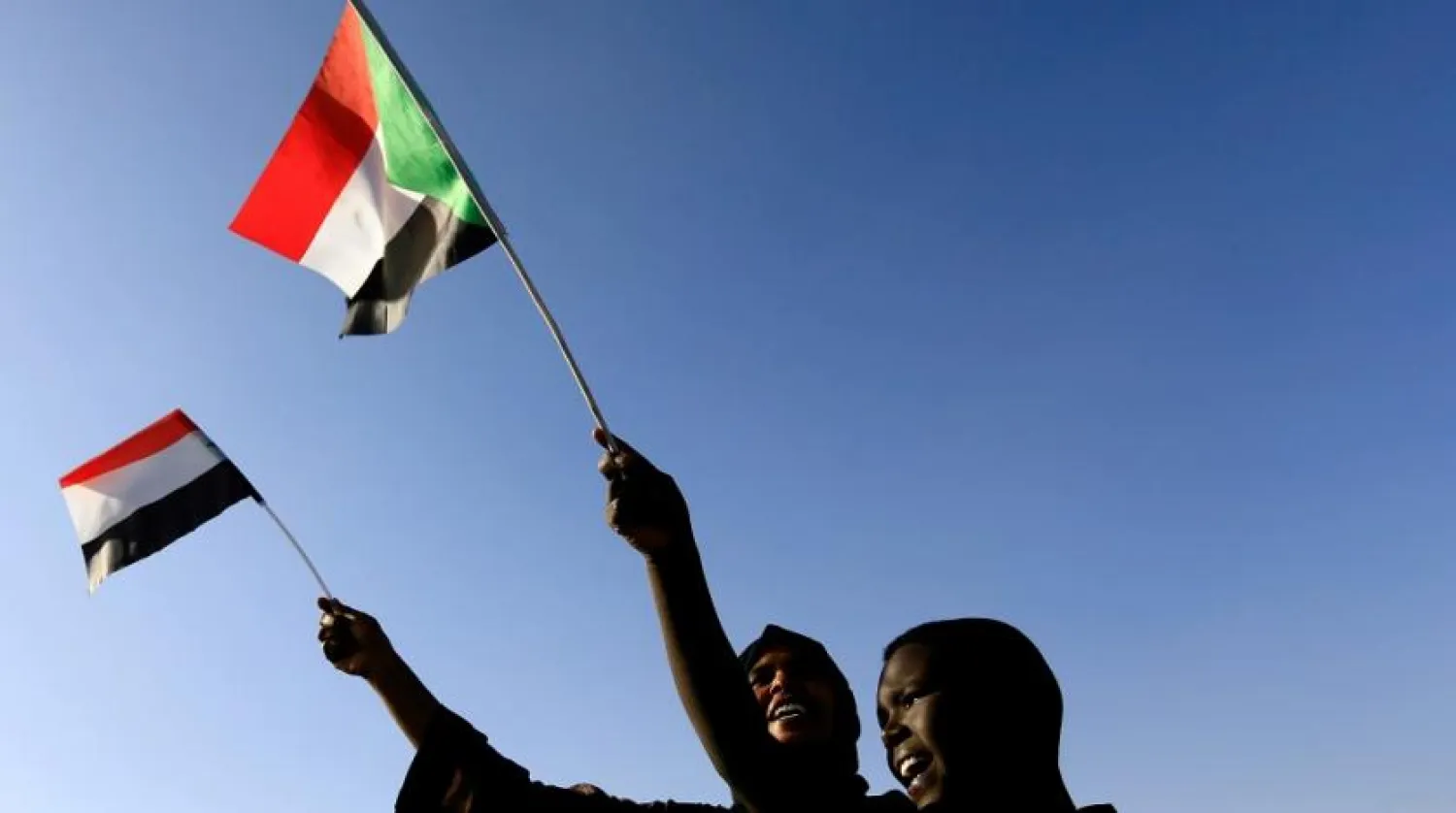 Sudanese civilians wave their national flag as they gather at the freedom square during the first anniversary of the start of the uprising that toppled Omar al-Bashir, in Khartoum, Sudan, Dec. 19, 2019. (Reuters)
