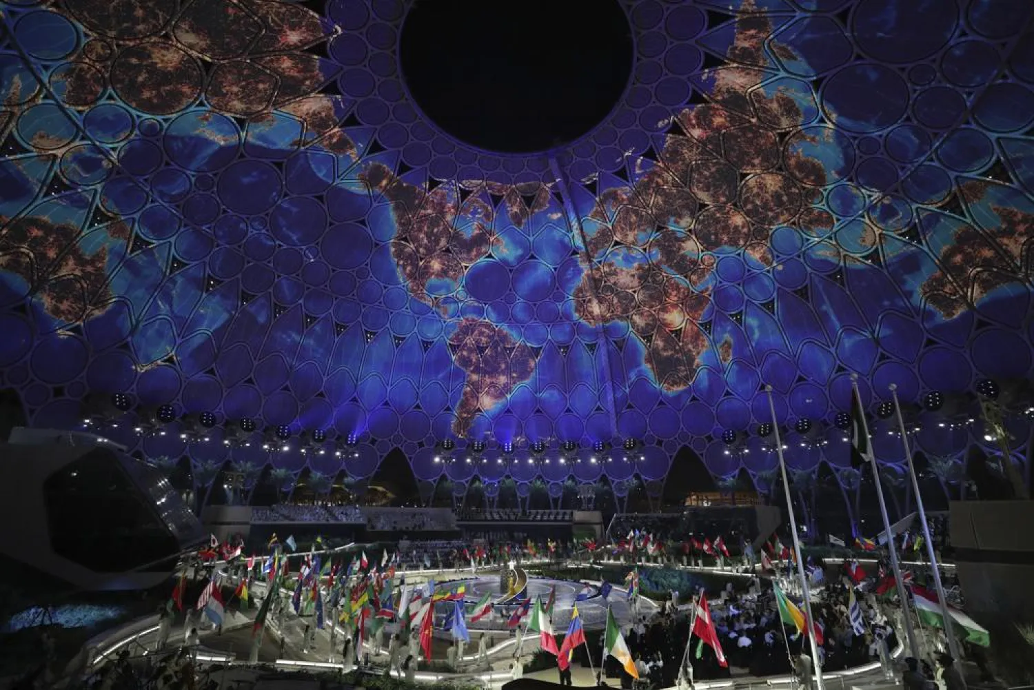 Artists carry national flags during the opening ceremony of the Dubai Expo 2020, in Dubai, United Arab Emirates, Thursday, Sept. 30, 2021. (AP Photo/Kamran Jebreili)
