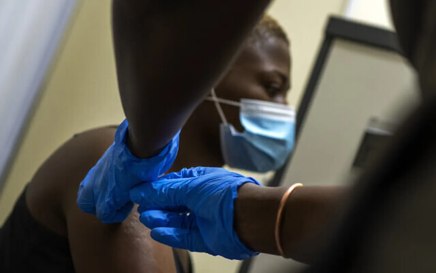 Illustrative: Thabisle Khlatshwayo receives her second shot at a vaccine trial facility for AstraZeneca at Soweto's Chris Sani Baragwanath Hospital outside Johannesburg, South Africa, November 30, 2020. (AP Photo/Jerome Delay)