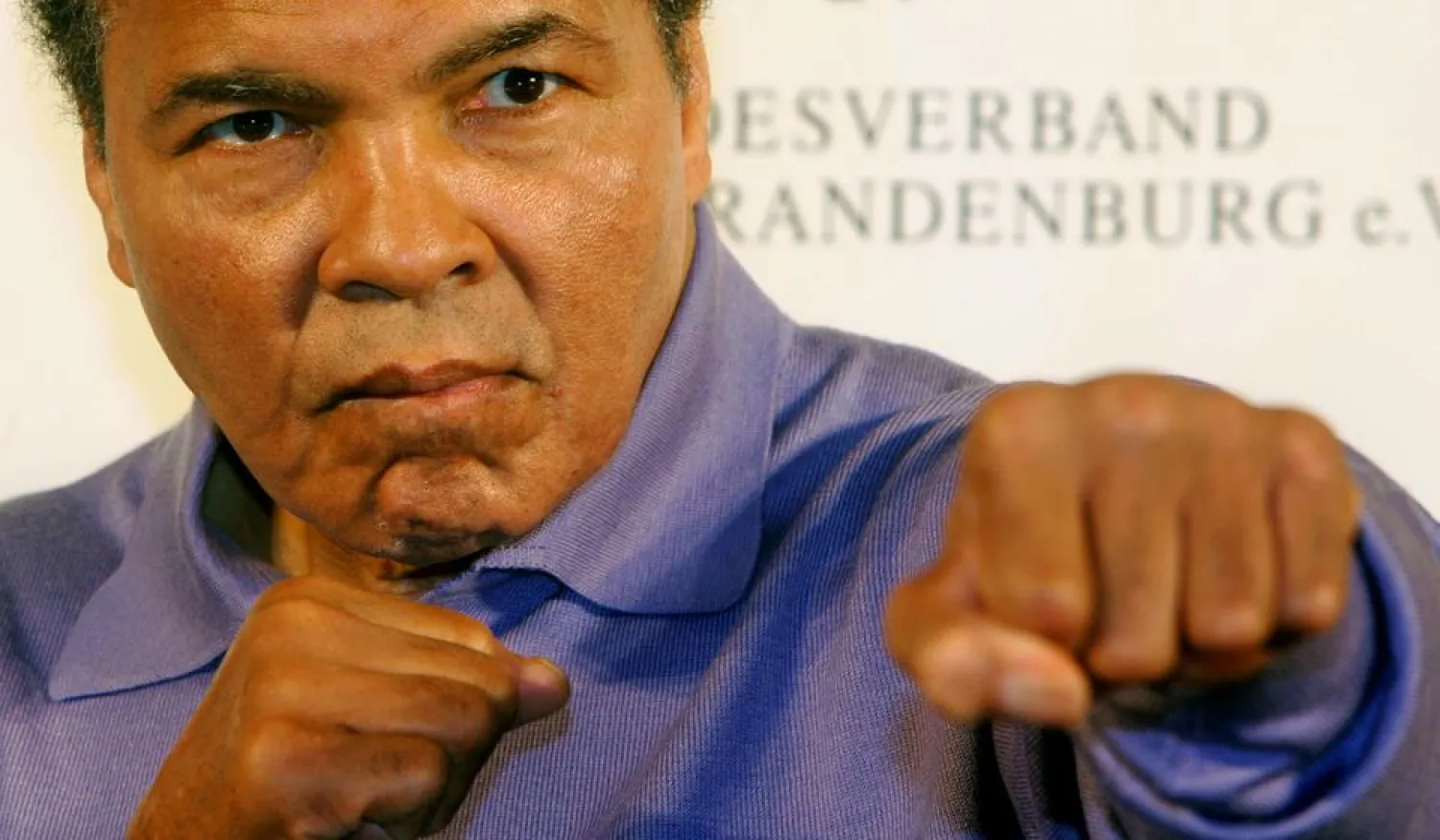 Boxing great Muhammad Ali poses for photographs during a news conference in Berlin in this December 16, 2005 file photo. (Reuters)