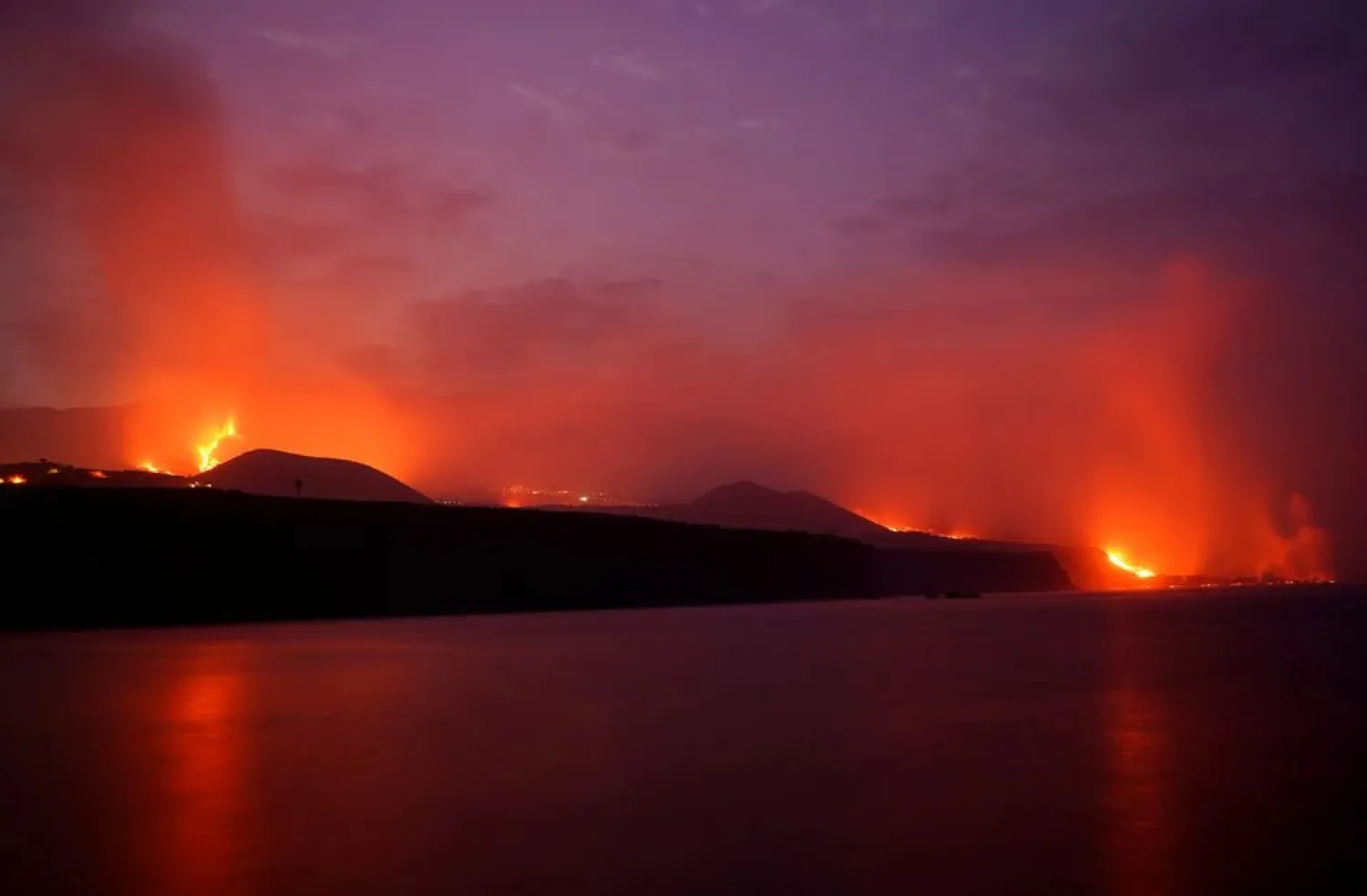 Lava flows following the eruption of a volcano on the Canary Island of La Palma, as seen from Tazacorte port, Spain, October 1, 2021. (Reuters)