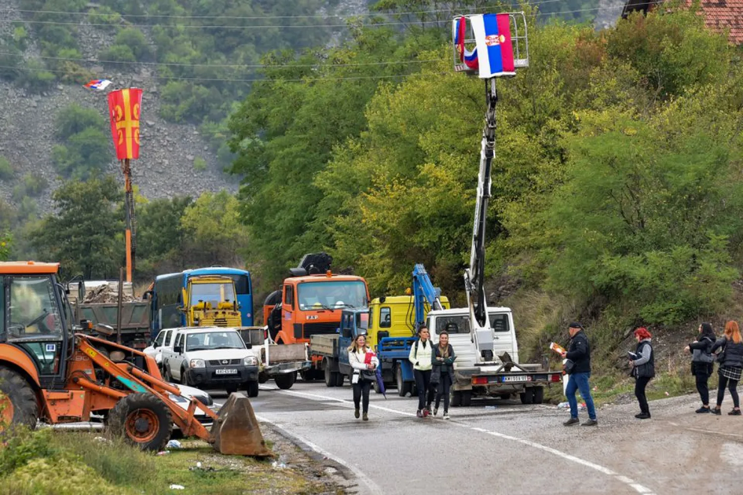 Kosovo ethnic Serbs pass through barricades near the border crossing between Kosovo and Serbia in Jarinje, Kosovo, September 28, 2021. REUTERS/Laura Hasani

