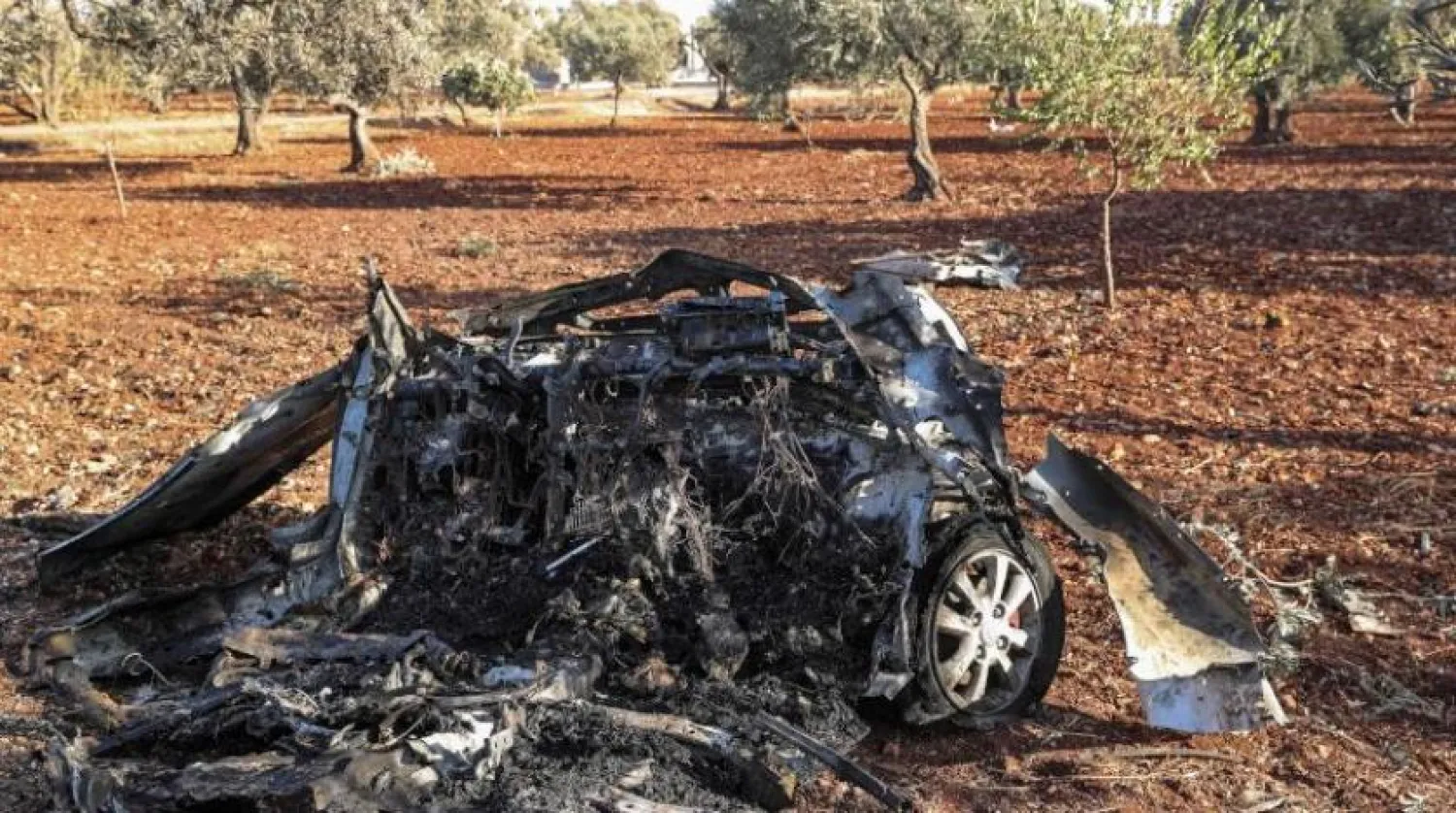 This file photo taken on September 20, 2021, shows the remains of a vehicle reportedly destroyed by a drone strike, on the northeastern outskirts of Syria's northwestern city of Idlib. (Photo by OMAR HAJ KADOUR / AFP)