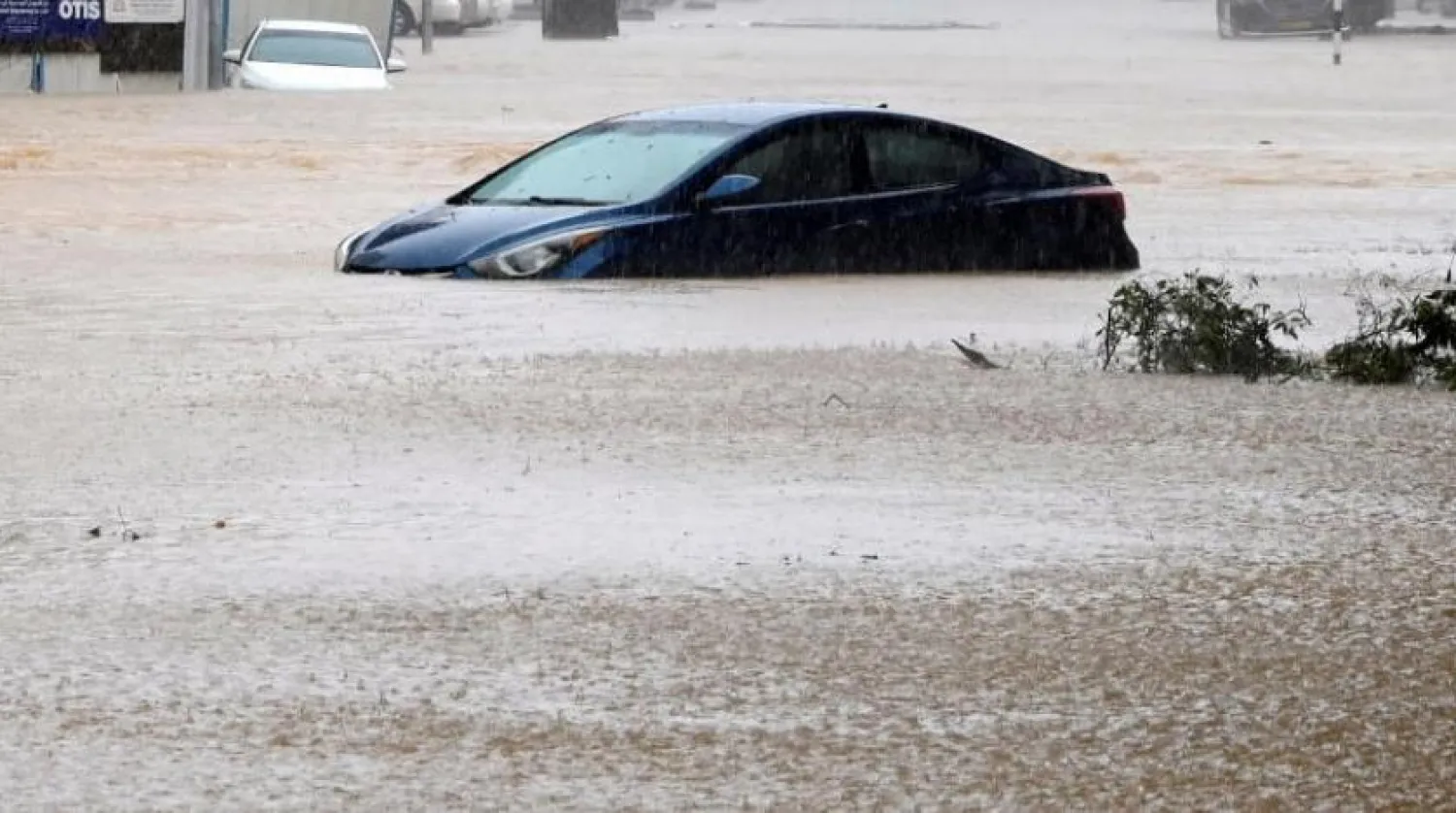 A car is partially submerged on a flooded street as Cyclone Shaheen makes landfall in Muscat Oman, October 3, 2021. REUTERS/Sultan Al Hassani 