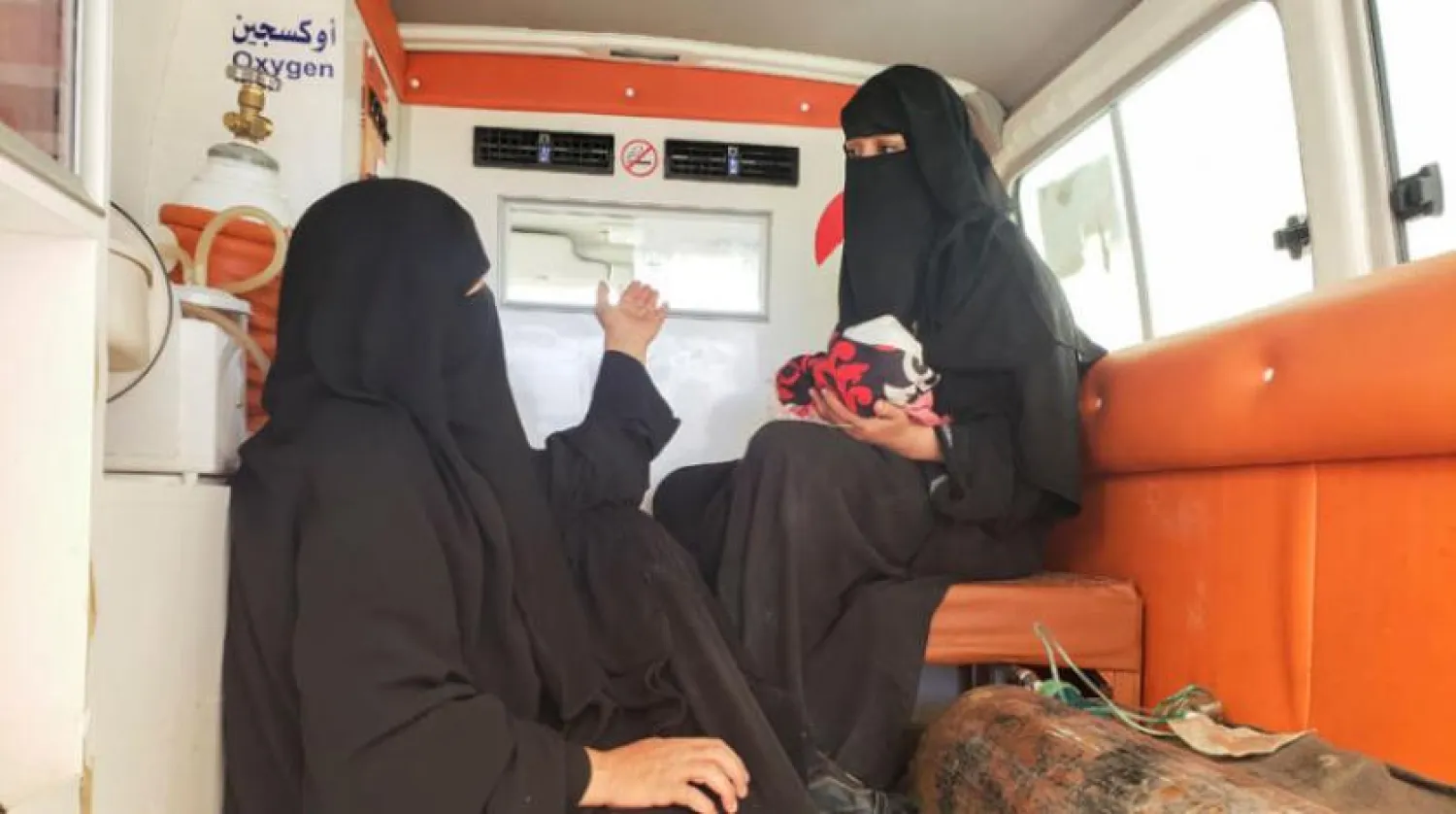 A woman carries her daughter, who was injured in a Houthi attack on Marib on Saturday. (Reuters)