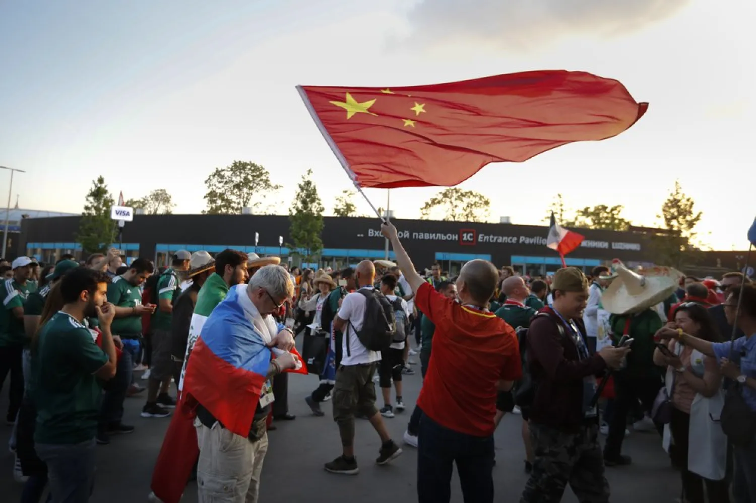 In this photo taken on Sunday, June 17, 2018, a Chinese soccer fan waves a China's national flag after the group F match between Germany and Mexico at the 2018 soccer World Cup in the Luzhniki Stadium in Moscow, Russia. (AP Photo/Alexander Zemlianichenko)


