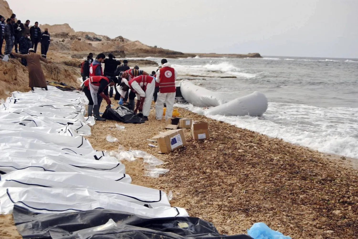 This Monday, Feb. 20, 2017 photo provided by The International Federation of Red Cross and Red Crescent Societies (IFRC), shows the bodies of people that washed ashore and were recovered by the Libyan Red Crescent, near Zawiya, Libya. (Mohannad Karima/IFRC via AP)
