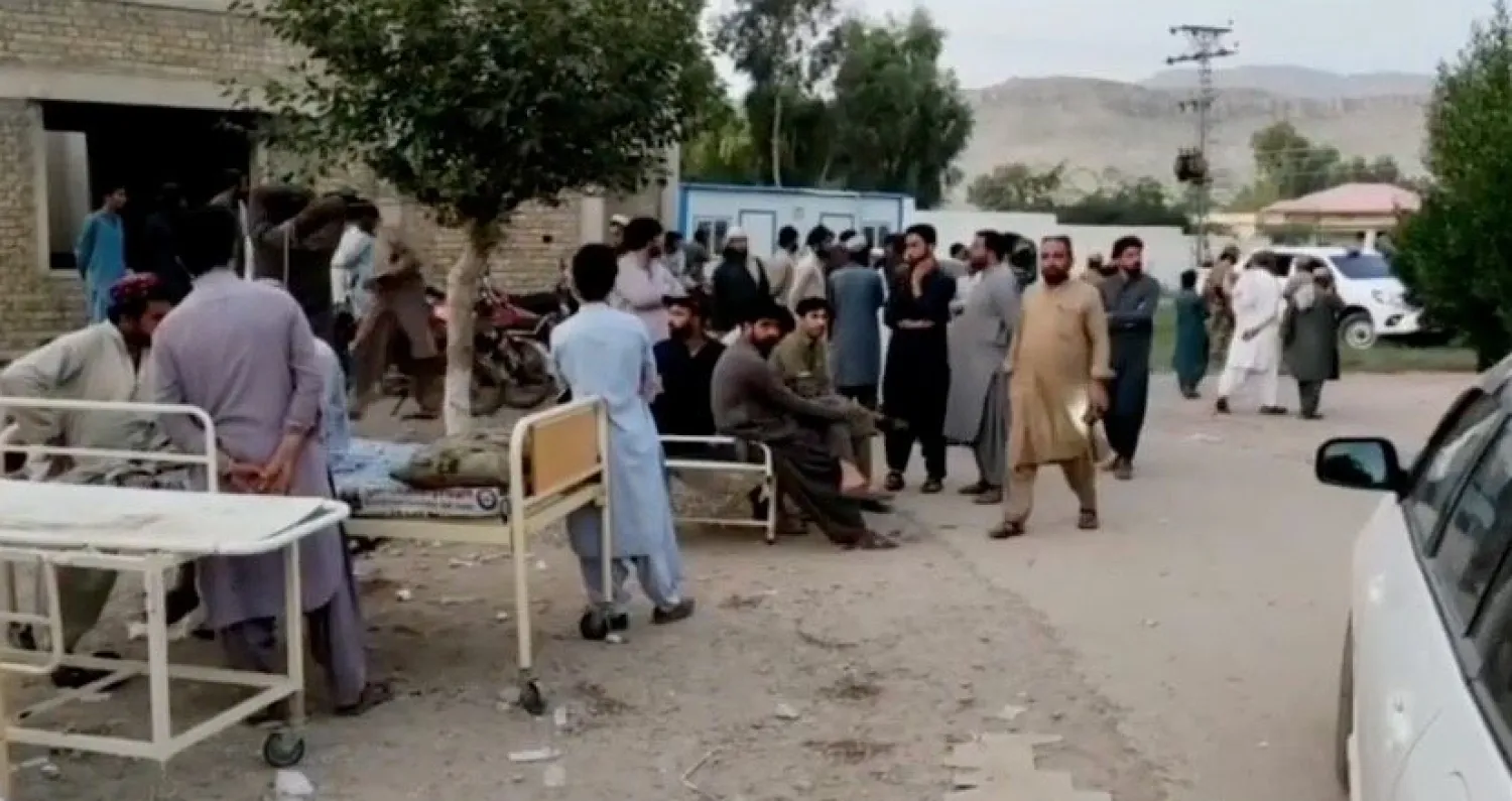 People gather outside a hospital following an earthquake in Harnai, Balochistan, Pakistan, October 7, 2021, in this still image obtained from video. Courtesy of QuettaVoice.com / Social Media via REUTERS


