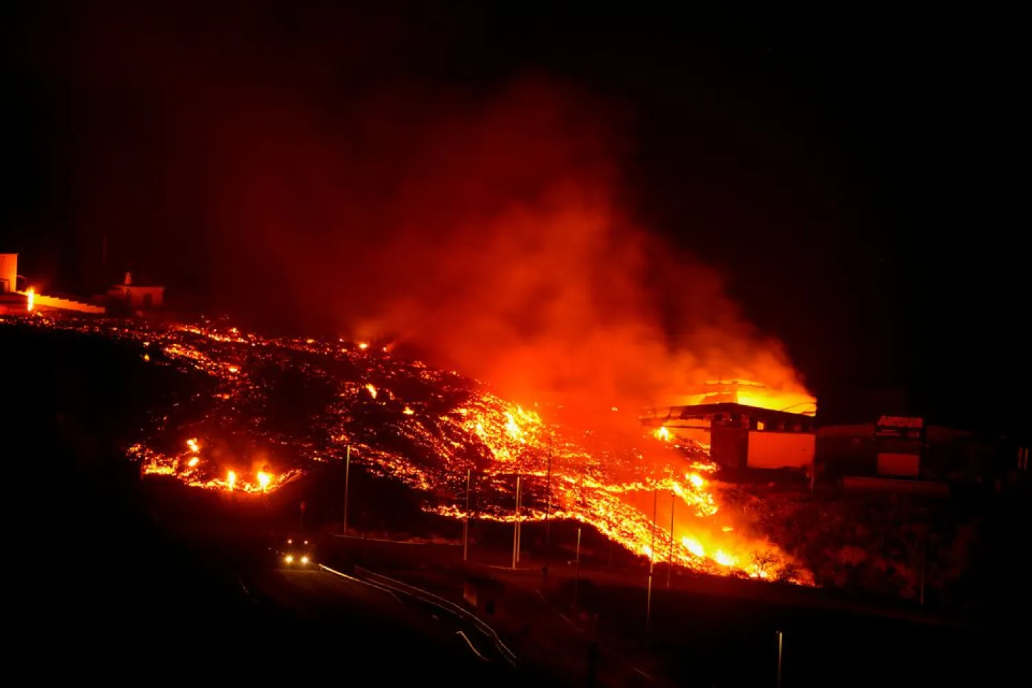 Lava burns buildings following the eruption of the Cumbre Vieja volcano, in Tacande, Spain, October 9, 2021. (Reuters)