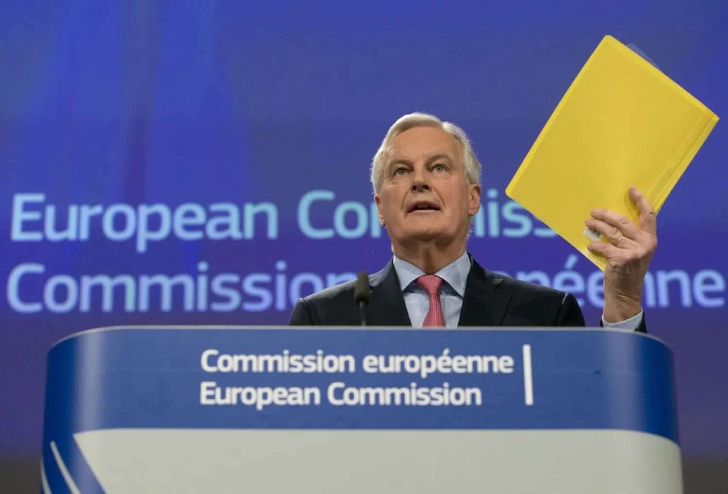 European Union chief Brexit negotiator Michel Barnier holds a draft document as he addresses a media conference at EU headquarters in Brussels on Wednesday, Feb. 28, 2018. (AP Photo/Virginia Mayo)
