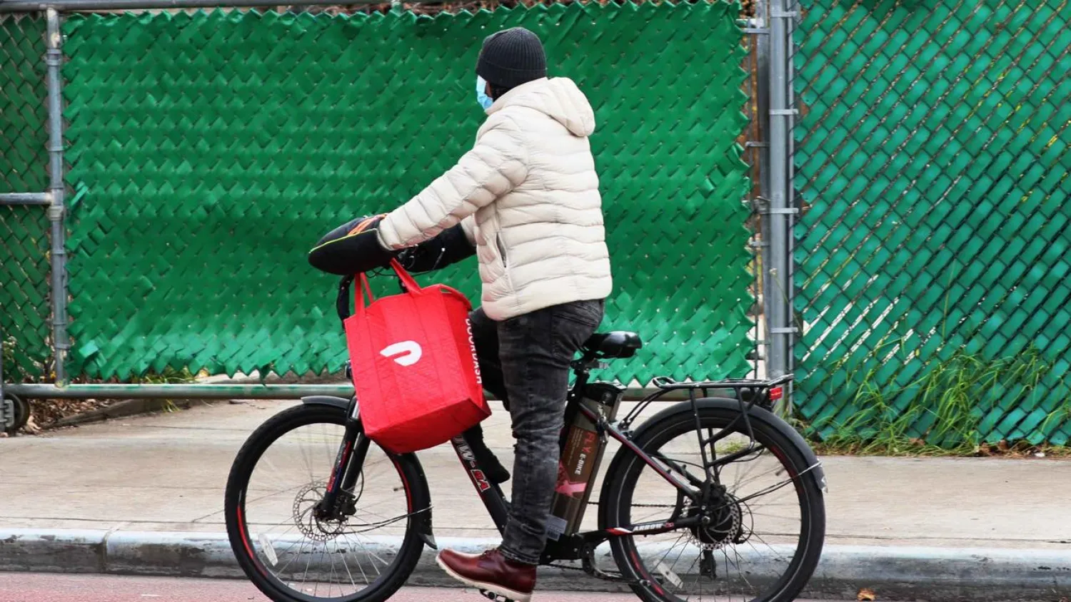 A DoorDash delivery person in Brooklyn in December 2020. Michael M. Santiago GETTY IMAGES NORTH AMERICA/AFP/File
