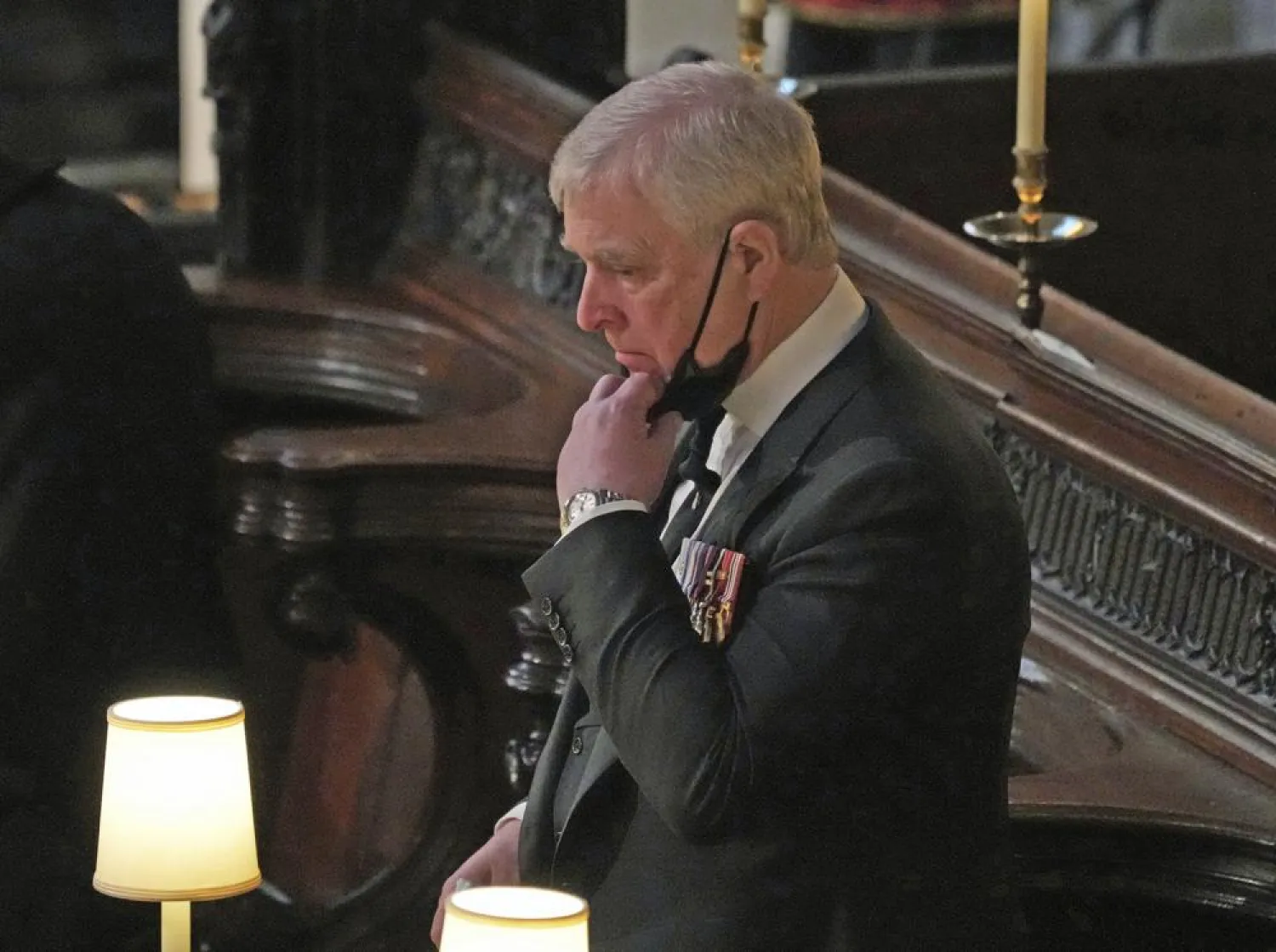FILE - Britain's Prince Andrew stands inside St. George's Chapel during the funeral of his father, Prince Philip, at Windsor Castle, Windsor, England, Saturday April 17, 2021. (Yui Mok/Pool via AP, File)
