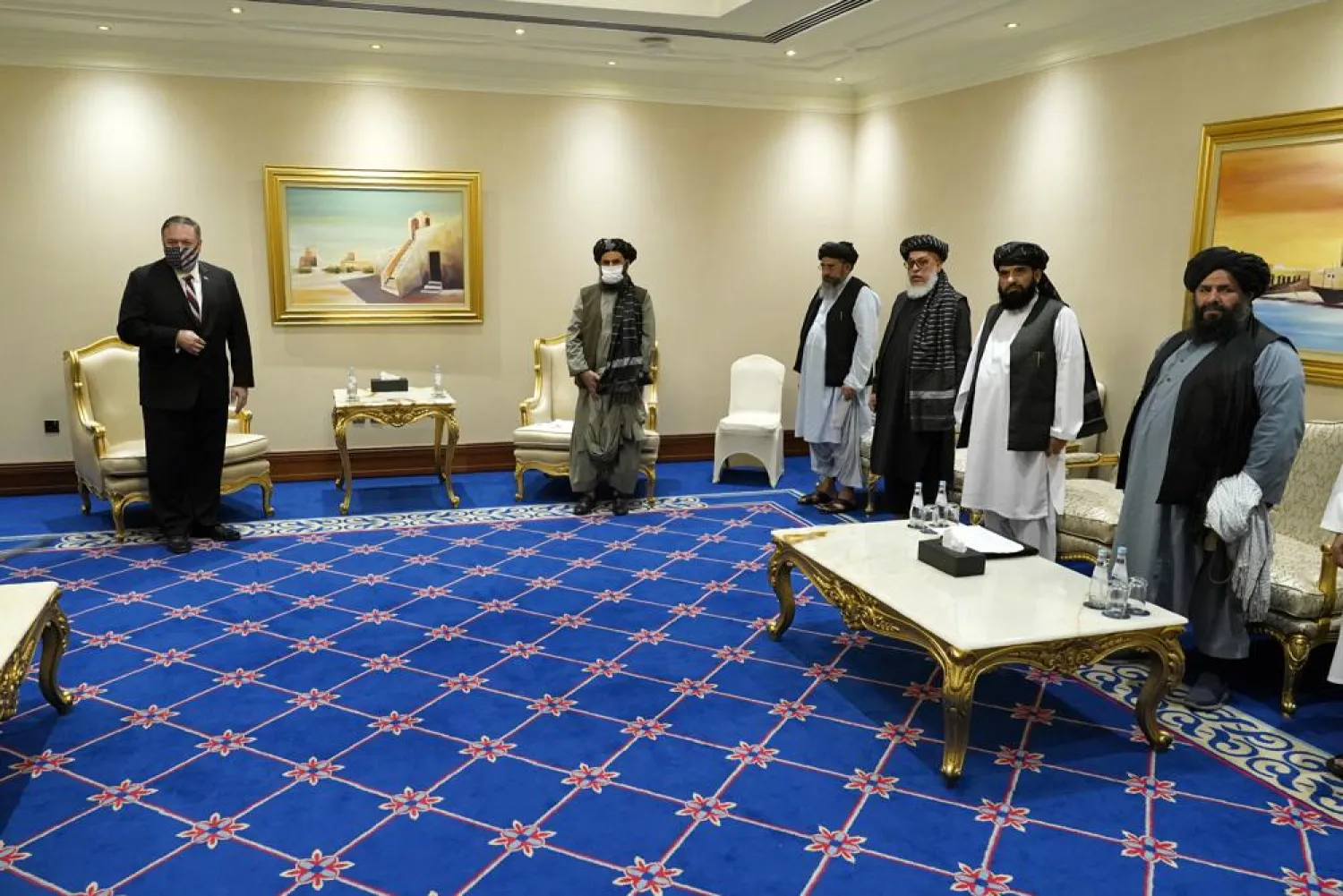 FILE - In this Nov. 21, 2020 file photo, US Secretary of State Mike Pompeo, left, meets with Mullah Abdul Ghani Baradar, second from left, and members of the Taliban's peace negotiation team, in Doha, Qatar. (AP Photo/Patrick Semansky, Pool)
