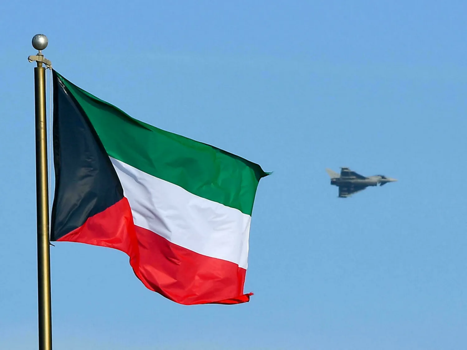 A fighter jet is pictured behind Kuwait's flag in Kuwait City in this file picture taken on November 18, 2018. (AFP)