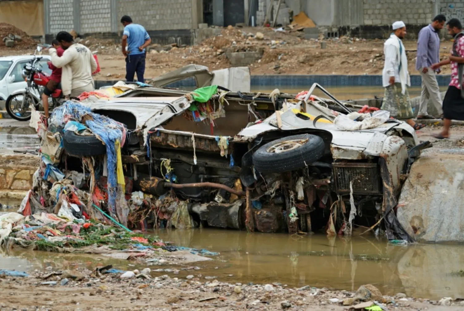 Cars were left upended in Mukalla’s water-logged, muddy streets - AFP