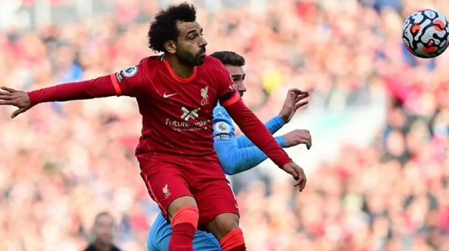 Egypt star Mohamed Salah (L) wins a heading duel during the Premier League draw between Liverpool and Manchester City at the weekend. - AFP