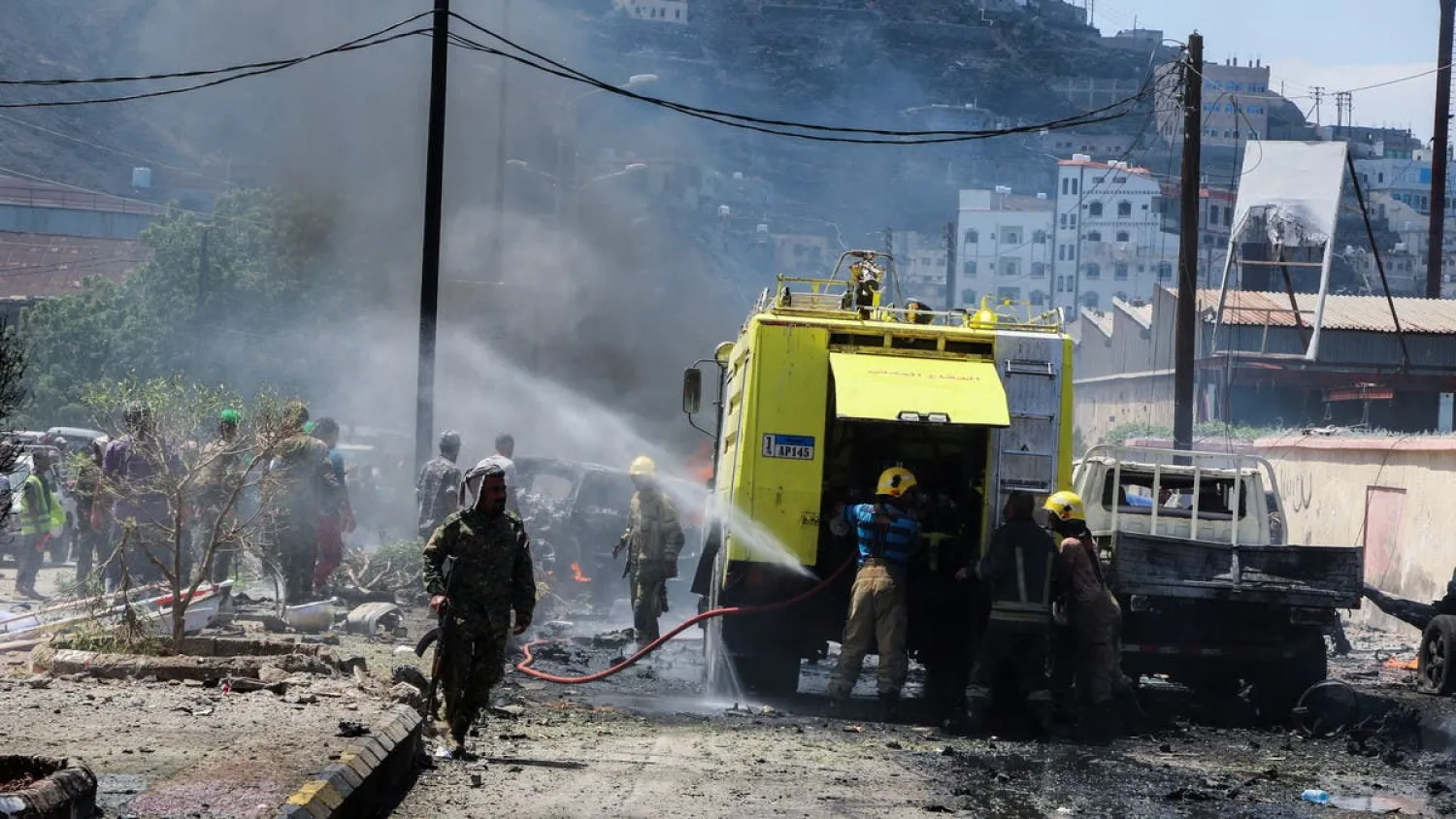 Policemen stand at the scene of a blast in Aden, Yemen, October 10, 2021. (Reuters)