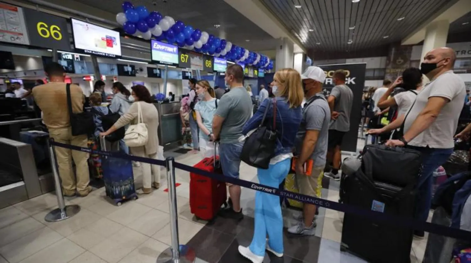 Russian tourists gather at the Egyptair check-in desk at the Domodedovo International Airport outside Moscow, Russia, Monday, Aug. 9, 2021. (AP)
