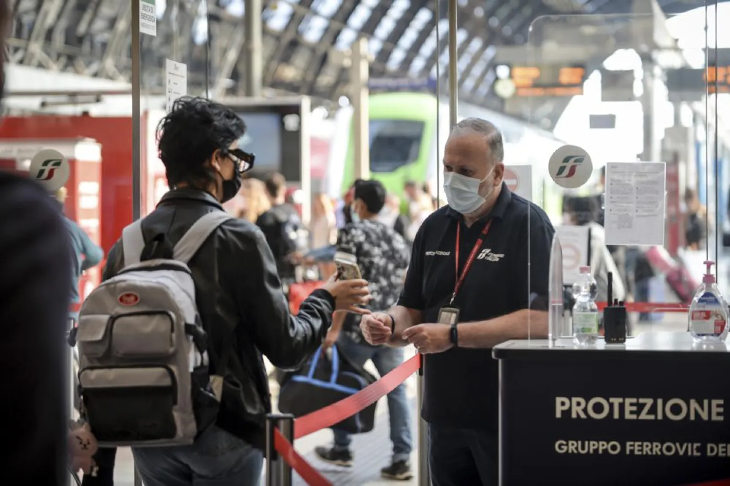 A passenger holds up his phone at a check point at Milan's Stazione Centrale train station, Italy, Wednesday, Sept. 1, 2021. (Claudio Furlan/LaPresse via AP)
