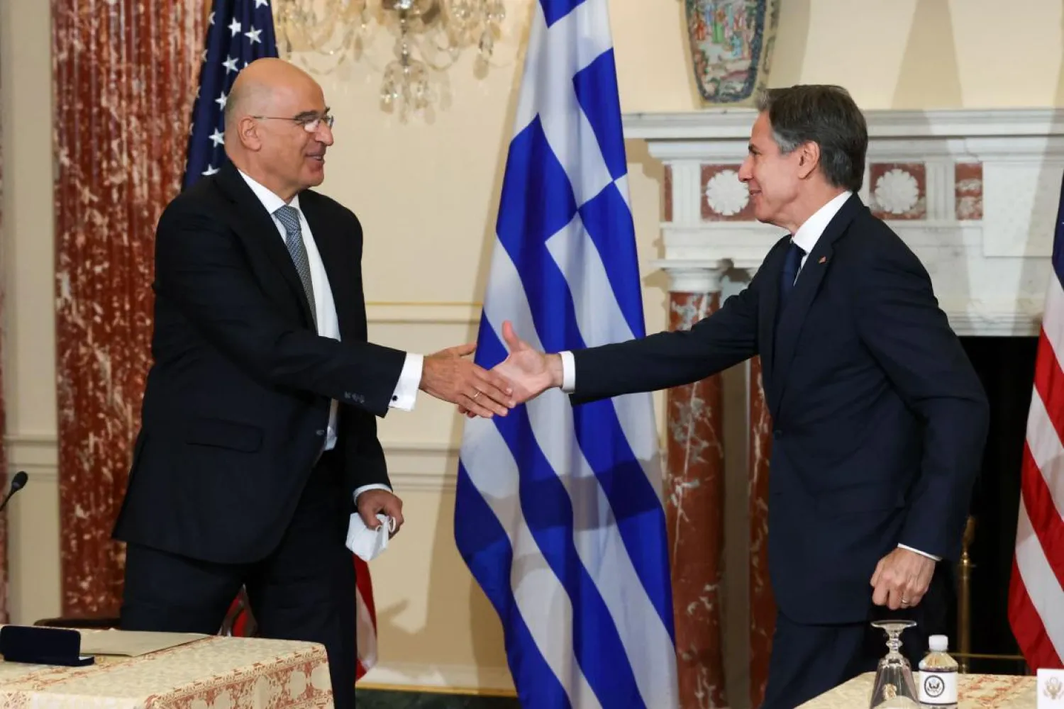 US Secretary of State Antony Blinken and Greek Foreign Minister Nikos Dendias shake hands after signing the renewal of the US-Greece Mutual Defense Cooperation Agreement at the State Department in Washington on Thursday. (AFP)