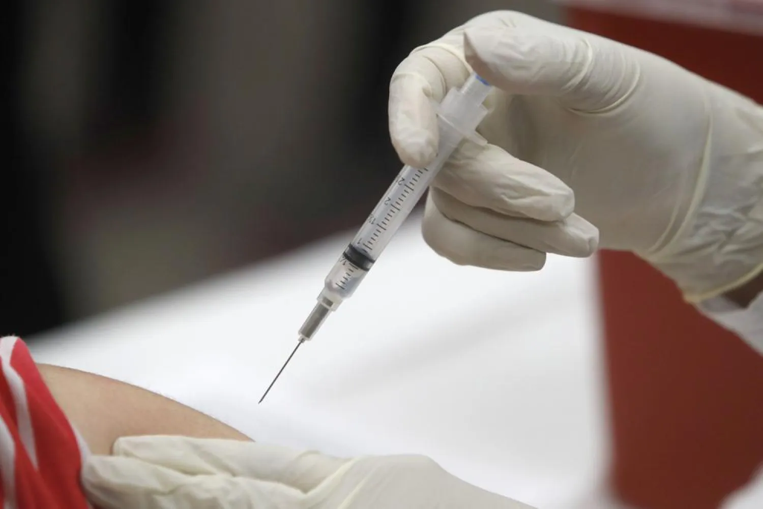 FILE - In this Thursday, Jan. 23, 2020, file photo, a patient receives an influenza vaccine in Mesquite, Texas. (AP Photo/LM Otero, File)
