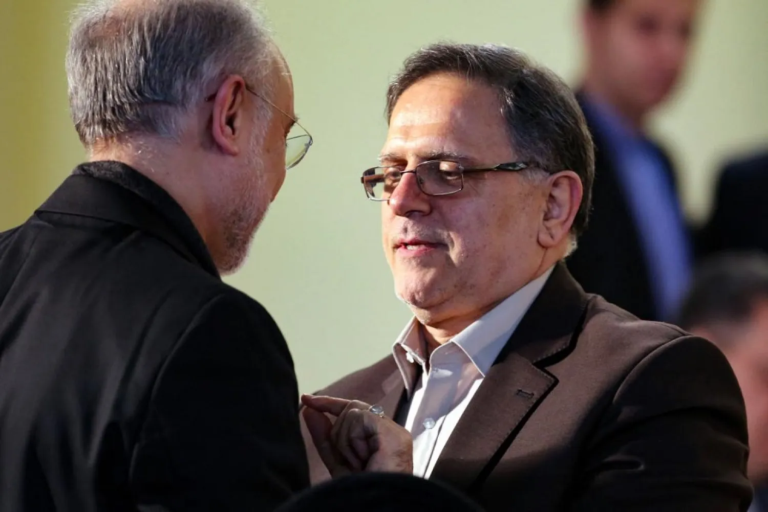 In this file photo taken on January 17, 2016, then head of the Central Bank of Iran, Valiollah Seif (R), speaks to Iran's head of Atomic Energy Organization (IAEO) Ali Akbar Salehi. (AFP file photo)
