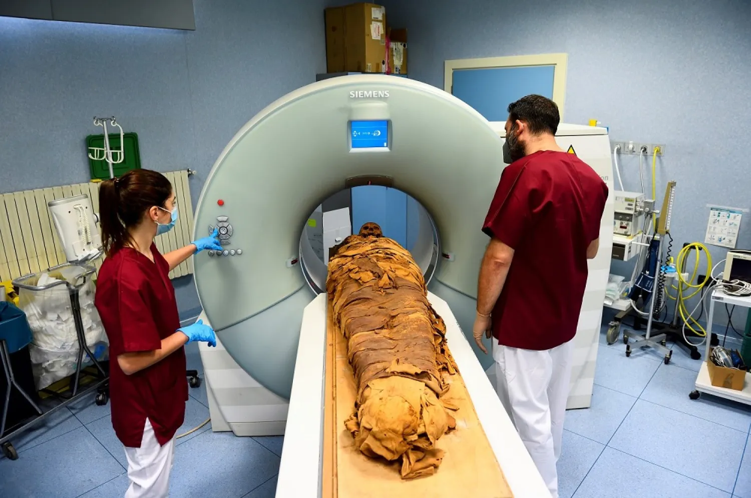 Medical radiology technicians prepare a CT scan to do a radiological examination of an Egyptian mummy in order to investigate its history at the Policlinico hospital in Milan, Italy, June 21, 2021. (Reuters)