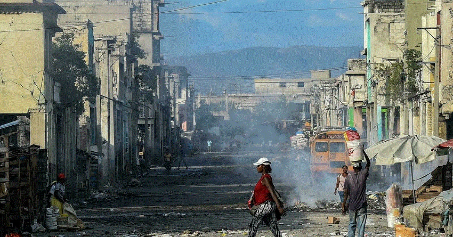 Haitians walk on a deserted street in Port-au-Prince, December 20 2019. © Chandan Khanna, AFP
