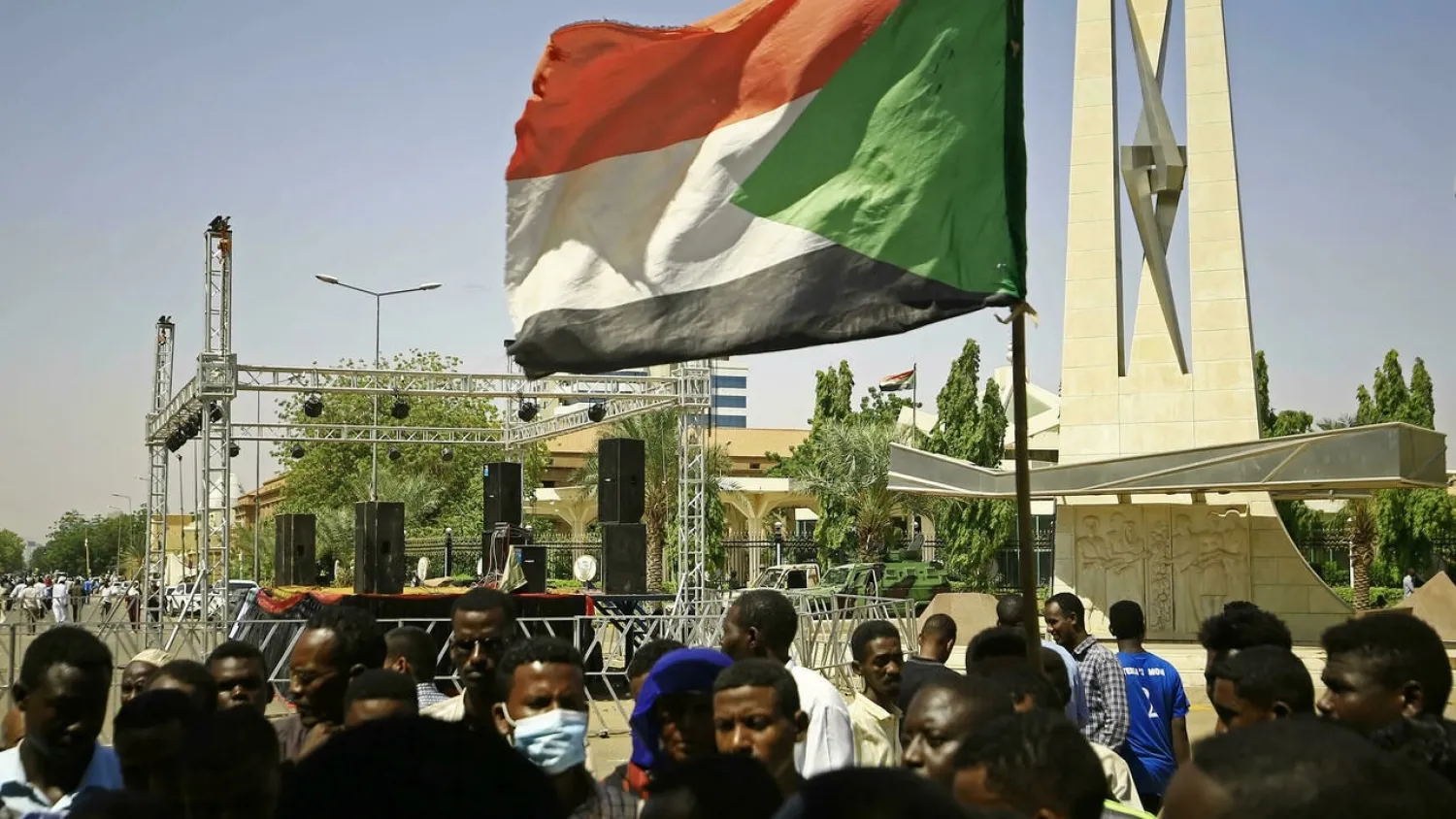 A Sudanese protester waves the national flag during a sit-in demanding the end to the interim government in Khartoum on Monday. (AFP)