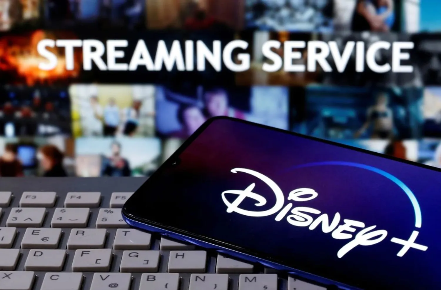A smartphone with the "Disney" logo is seen on a keyboard in front of the words "Streaming service" in this picture illustration taken March 24, 2020. (Reuters)
