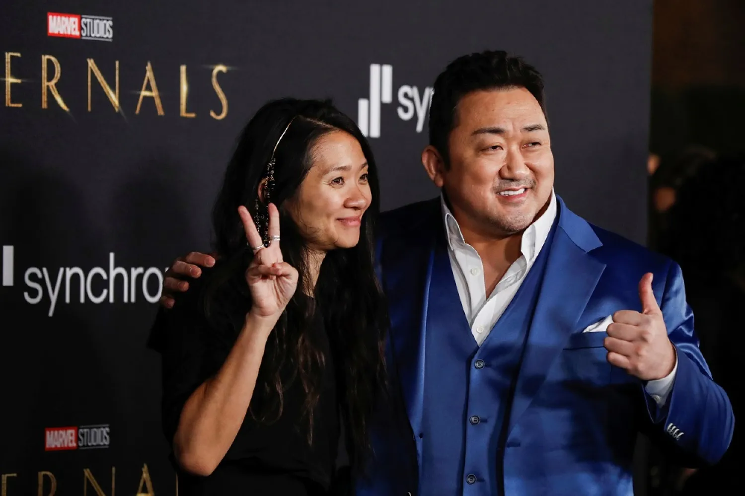 Cast member Ma Dong-seok, also known as Don Lee, poses with director Chloe Zhao at the premiere for the film “Eternals” in Los Angeles October 18, 2021. (Reuters)